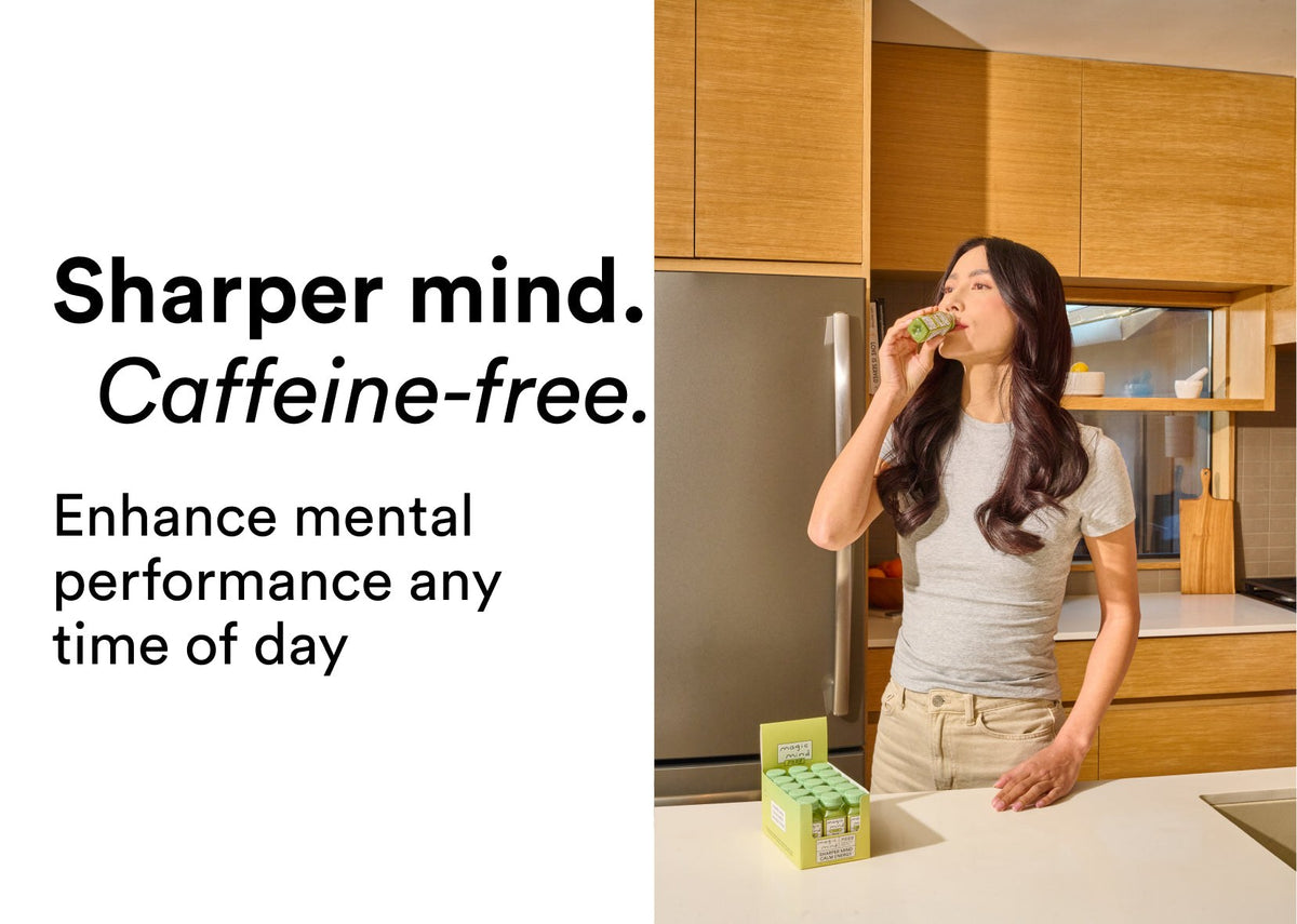 Woman drinking Clear Focus Shot in her kitchen, caffeine-free focus any time of day