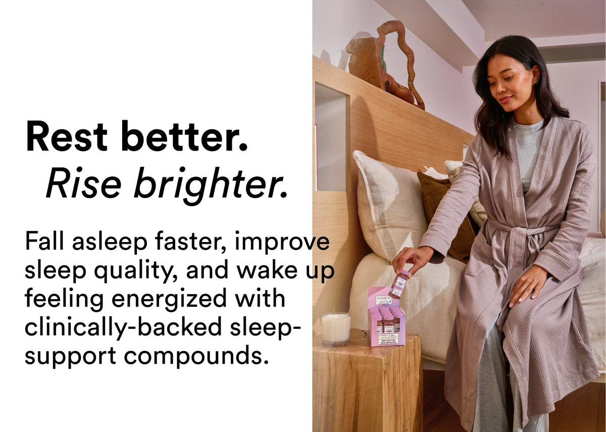 Woman in a robe reaching for a Dusk Sleep Shot bottle at bedtime